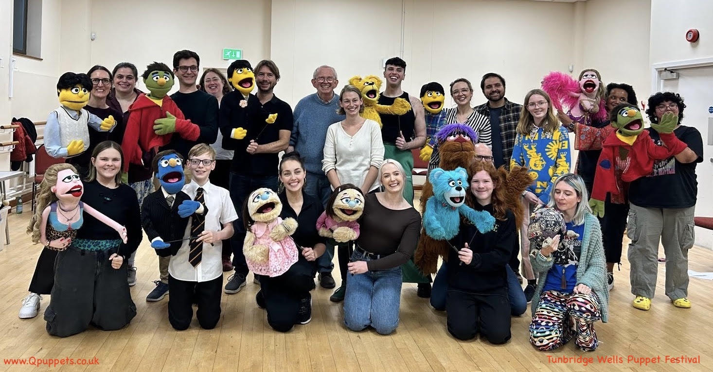 A group of people holding puppets